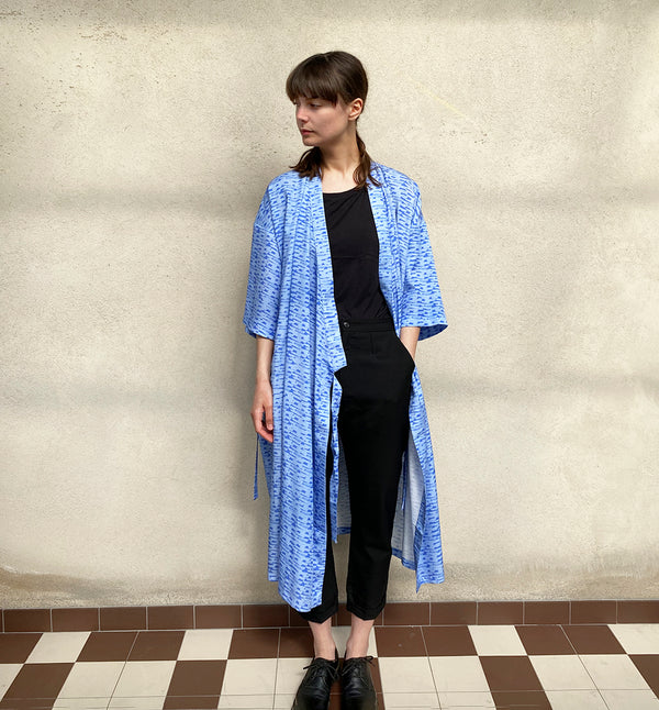 Vår kimonoklänning Mika i rak modell med omlottknyt och fickor i sidorna. Fin både som klänning och lång kimono.  Färg: Blå med våg- och bergmönster i mörkare blå. Material:  100% Lyocell