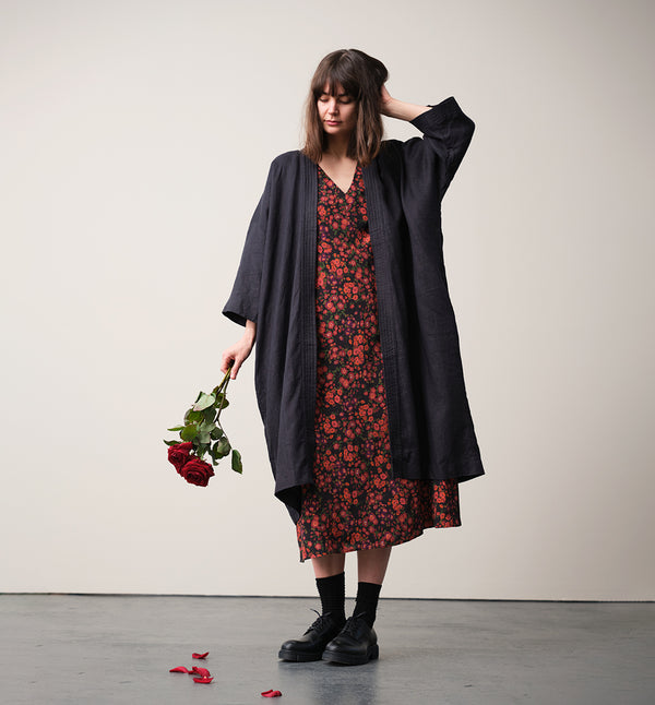 Vår klänning Nea! V-ringad, söm i midjan, trekvarts ärm med smal manschett och knapp, fickor i sidorna.  
Färg: Blommor i roströda, mörklila, gröna och orangea toner på svart botten.
Material: 51% EcoVero, 49% viskos från Frankrike.