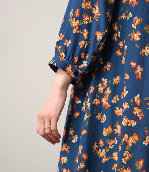 Vår klänning Nea Paradiso! V-ringad, söm i midjan, trekvarts ärm med smal manschett och fickor i sidorna.  
Färg: Blommor i gula, beiga och gröna toner på blå botten.
Material: 51% EcoVero, 49% viskos från Frankrike.