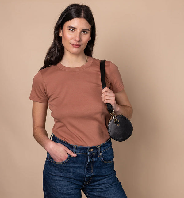 Handväska Izzy är O My Bag:s unika cylinderformade handväska som förkroppsligar den där edgy och retro, men ändå minimalistiska stilen. Denna cross-body-väska är tillverkad av hållbart ekologiskt läder. Izzys eleganta och moderna design gör att den passar lika bra till vardag som till fest. Den justerbara remmen gör att den kan bäras på olika sätt, som en cross-body-väska eller kortare för ett elegant axelalternativ. Svart läder. 