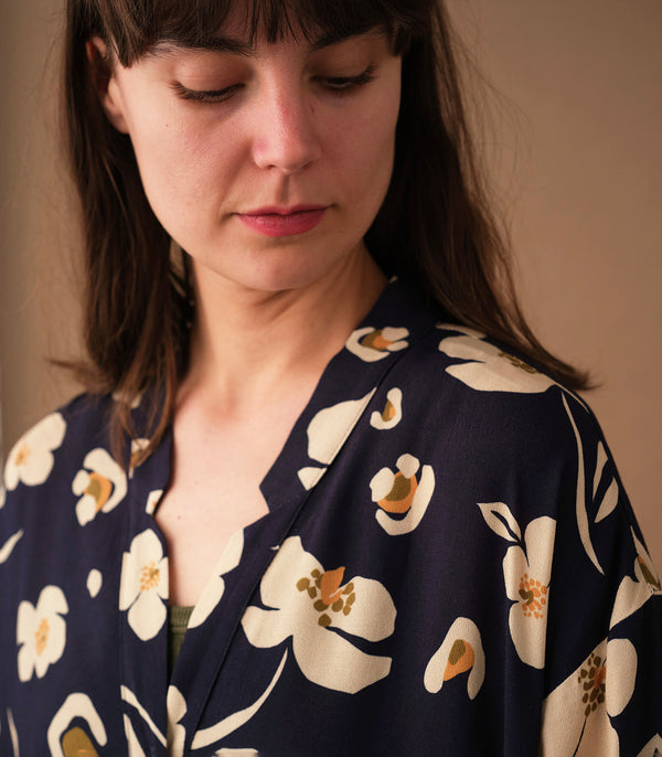 klänning Naja Sonett. En ankellång klänning med fina kragdetaljer. Ok med veck i ryggen, fickor i sidorna. Naja är fin både öppen och stängd. Små mörkblå knappar mitt fram. Sydd i en ekologisk viskos.

Färg: Gräddvita blommor med gula och olivgröna detaljer på mörkblå botten.

Material:&nbsp;51% EcoVero, 49% viskos från Frankrike.
Designad i Malmö, tillverkad i Litauen