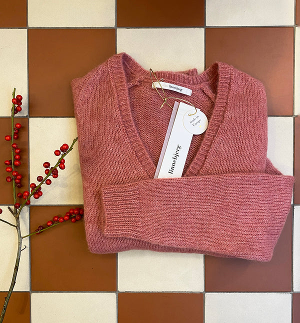 V-ringad stickad tröja Lavender från Sibin Linnebjerg i mjuk ullblandning.&nbsp;

Färg: Varmrosa

Material: 50% alpacka, 30% polyamid, 20% ull.&nbsp;Certifierad mulesingfri ull. Garnet kommer från Italien.

Tillverkad i: Serbien

Tvätt:&nbsp;30 grader fintvätt