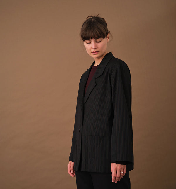Vår kavaj Sonia Kritstreck. En avslappnad kavaj. Helfodrad och fickor fram. Sydd i ett deadstock tyg.

Färg: Svart med grå och roströda streck, svart foder.

Material: Yttertyg: 100% ull, deadstock. Foder: 60% acetat, 40% viskos från Italien.