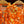 Load image into Gallery viewer, Klänning Svavel från Bric-a-brac. Bandkrage med rynk, knappslå med fem pärlemorknappar, fickor i sidorna. Band medföljer.  Färg: Vita och gula blommor på korallorange botten.   Material: 100% bomull
