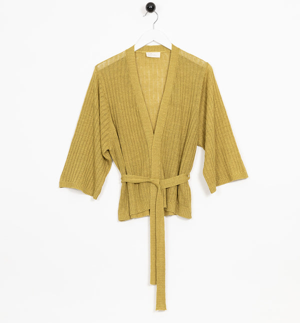 Kimonoliknande omlottkofta Hakesta från Bric-a-brac. Skärp i midjan, bred ribbstickning och vida ärmar. Finns i tre storlekar, XS, M, XL.

Färg: Mässingsgul

Material: 72% linne, 28% bomull.

Skötselråd: 30 grader fintvätt

Tillverkad i: Italien