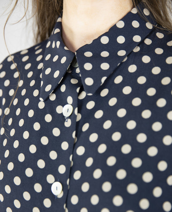 Blus Helgum från Bric-a-brac. Krage, armbågslång ärm, pärlemorknappar fram.&nbsp;

Färg: Vita prickar på mörkblå botten

Material: 100% FSC EcoVero.

Skötselråd: 30 grader fintvätt. Strykes efter tvätt. 2% i längd.

Tillverkad i:&nbsp;Litauen